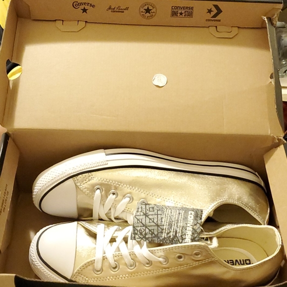 A brand new pair of Gold and White Converse